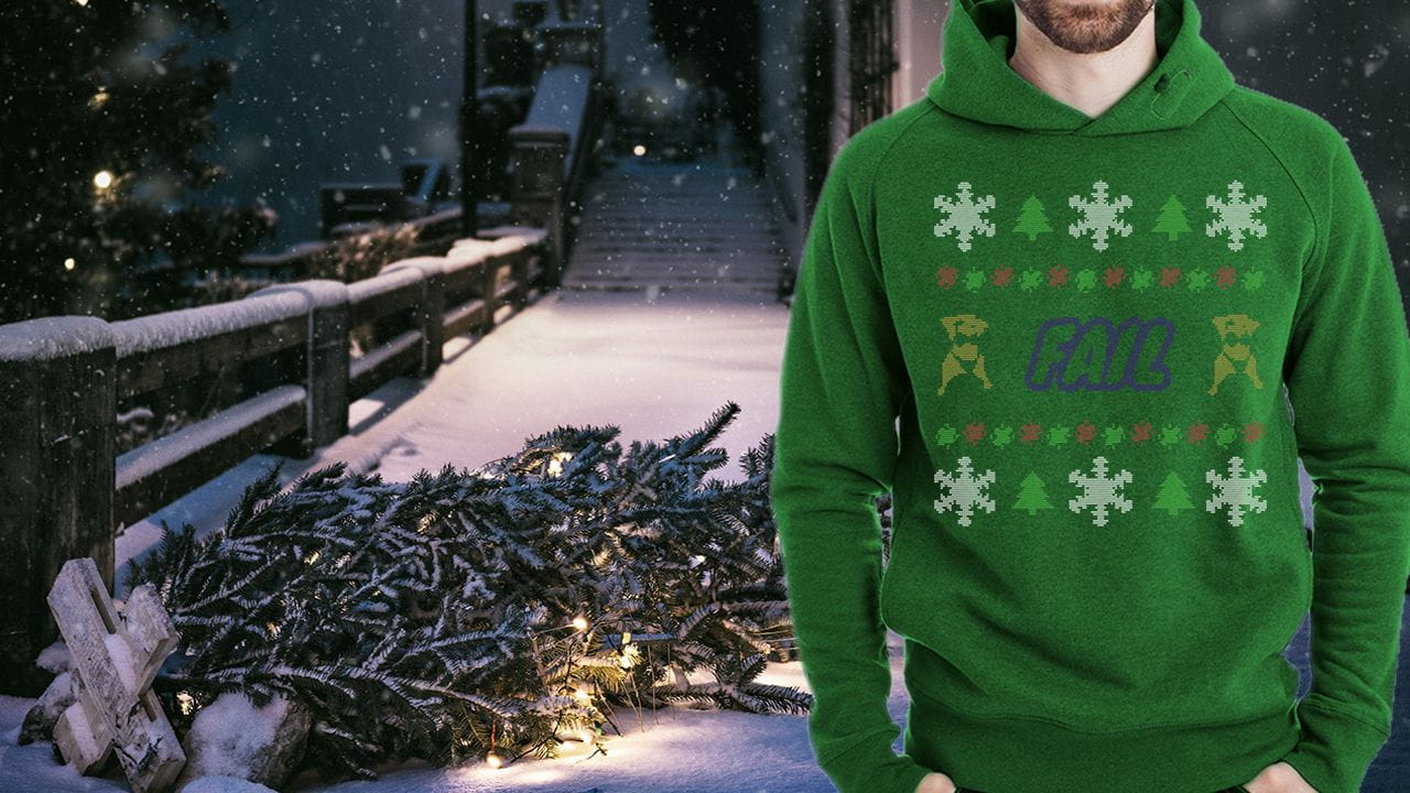 Fallen tree in snow with the new Holiday Sweater design displayed in front.